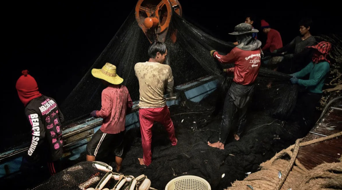 people working on a fishing boat for pennies on the dollar