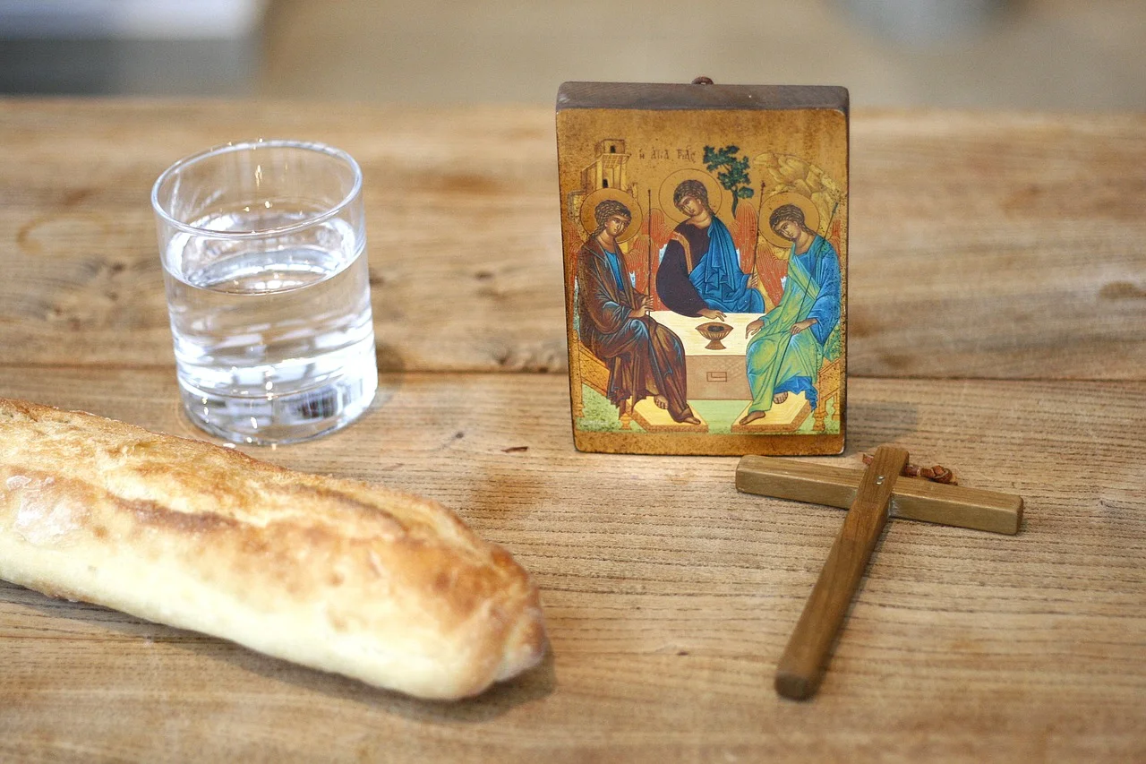 A simple monastic fasting meal of bread, vegetables, and olives on a wooden table