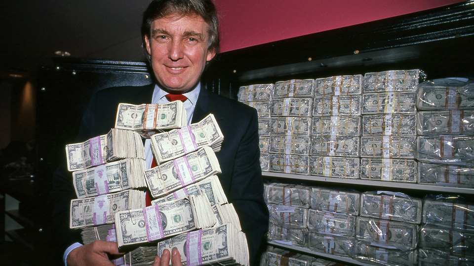 Donald Trump surrounded by money representing the Trump family's unprecedented financial enrichment during his second presidency